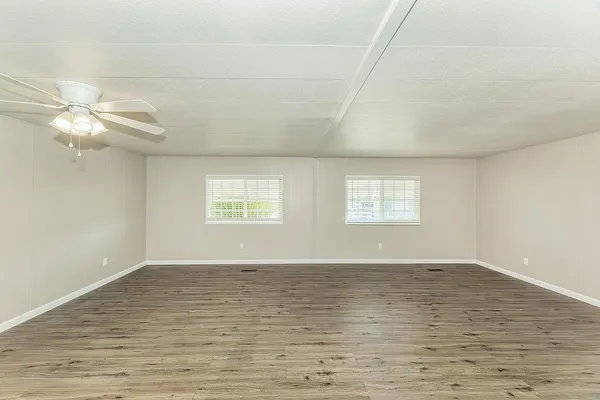 a kitchen with cabinets oven and a dishwasher with wooden floor