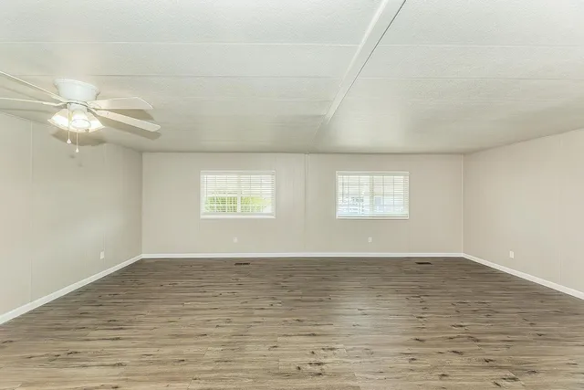 a kitchen with cabinets oven and a dishwasher with wooden floor