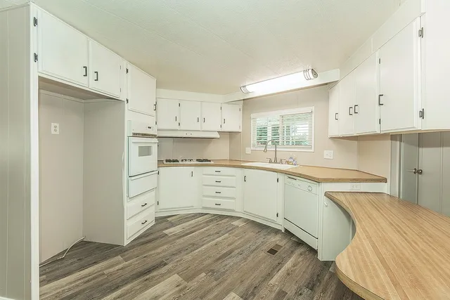 a kitchen with stainless steel appliances a refrigerator and wooden cabinets