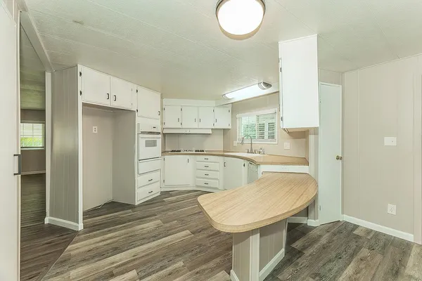 a view of a kitchen with wooden floor