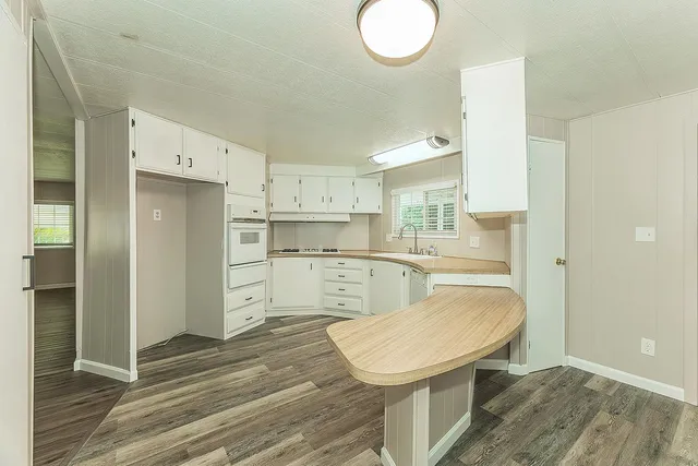 a view of a kitchen with wooden floor