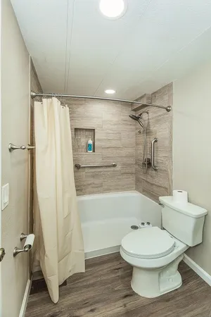 a view of an empty room with wooden floor