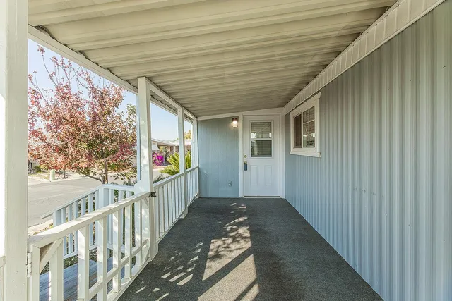 a view of a porch with wooden floor