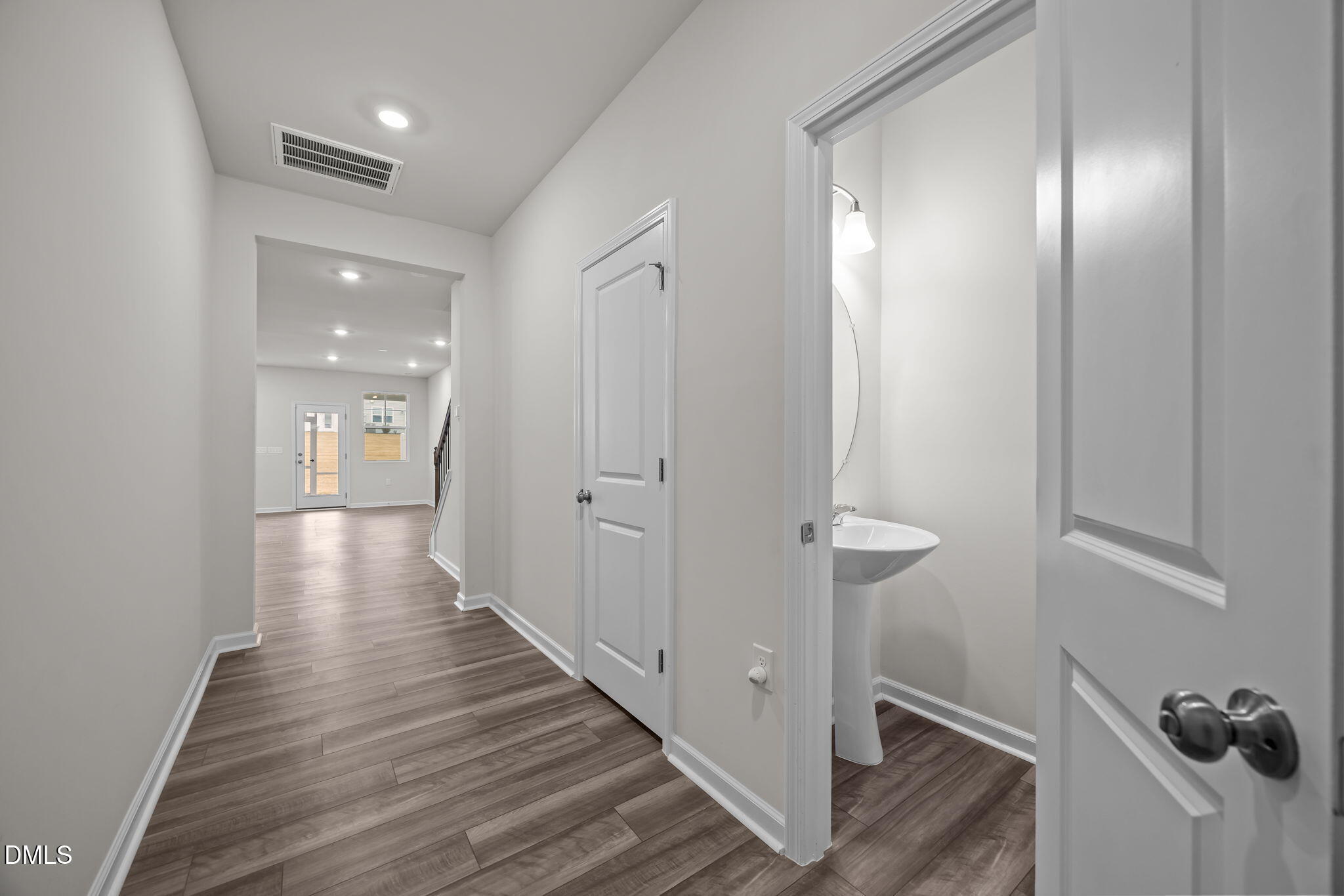 5016 Kota Street Raleigh, NC 27610 - Photo 31 of 37 a view of a hallway with wooden floor and staircase