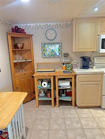 a view of kitchen with cabinets and window