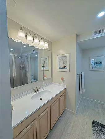 a bathroom with a sink a large mirror and a shower