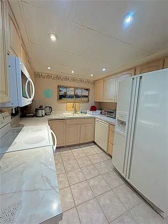 a kitchen with stainless steel appliances granite countertop a refrigerator sink and cabinets