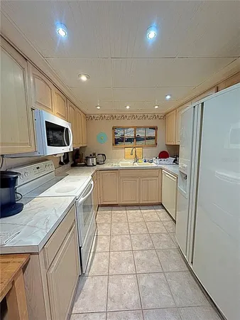 a kitchen with a sink a counter top space cabinets and stainless steel appliances