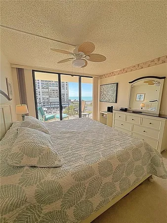 a large bed sitting in a bedroom next to a window