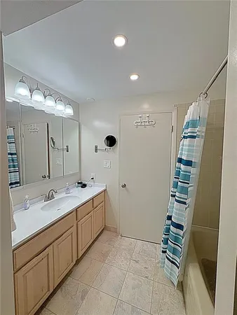 a spacious bathroom with double vanity and mirrors