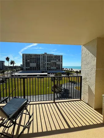 a view of balcony with two chairs and a table