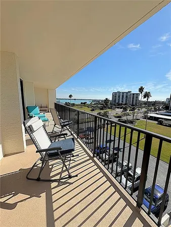 a view of a balcony with chair and wooden floor