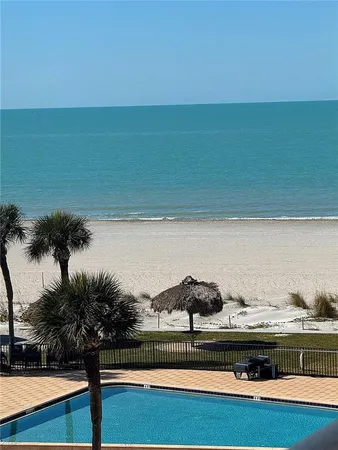 a view of white house with a potted plant and a chair