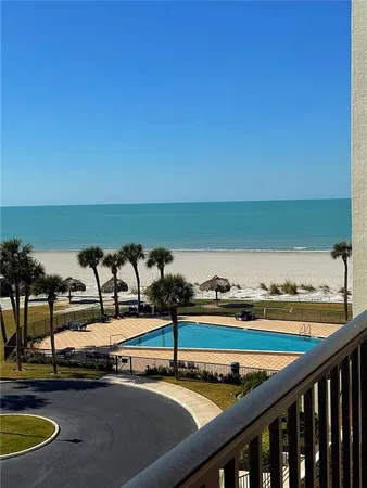 a view of a swimming pool with a table and chairs