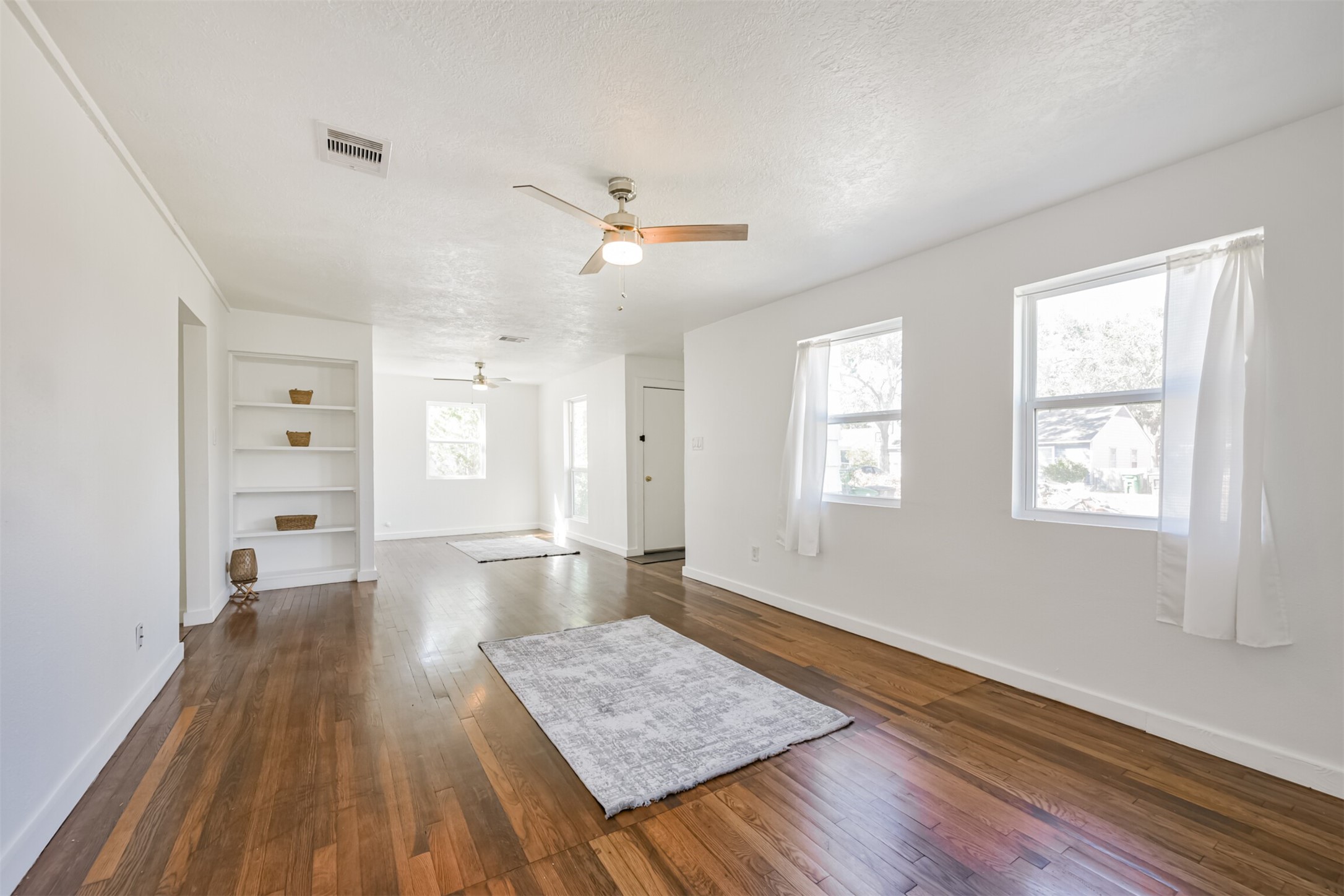 7546 Greendowns Street Houston, TX 77087 - Photo 8 of 33 wooden floor in an empty room with a window