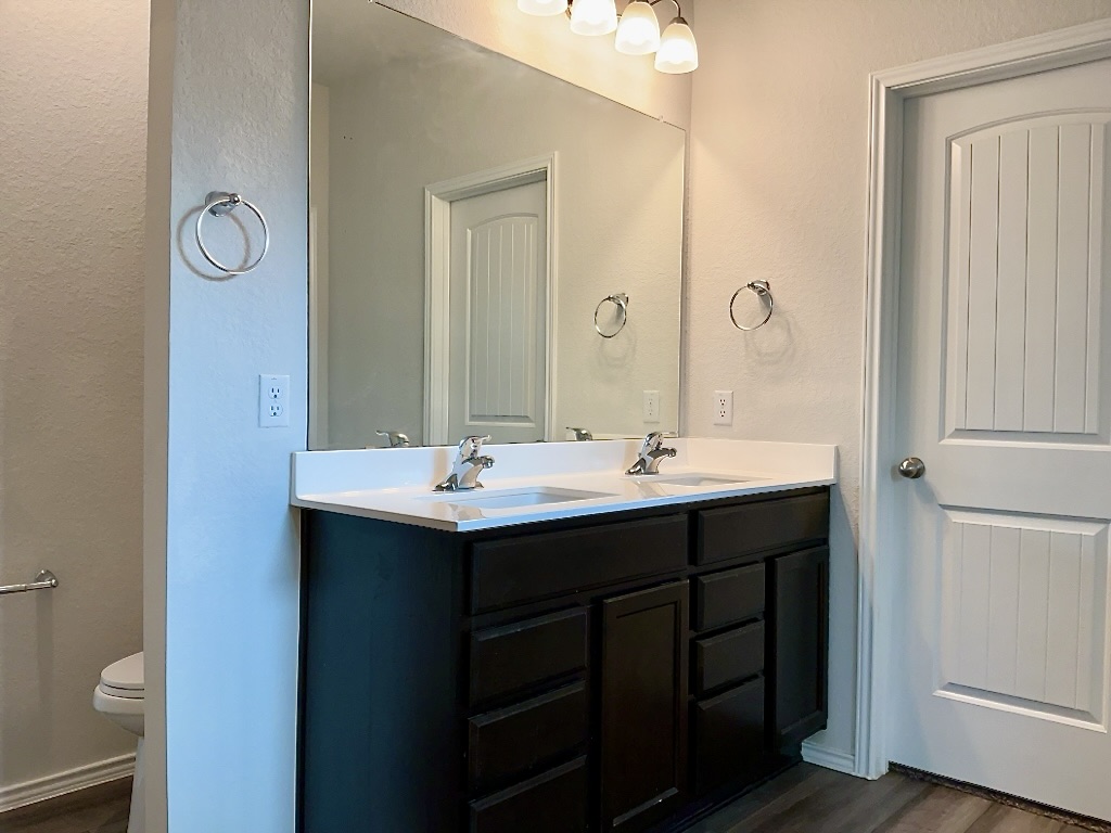 124 Marcel Court Taylor, TX 76574 - Photo 8 of 17 Primary bathroom with dual sinks and walk-in closet