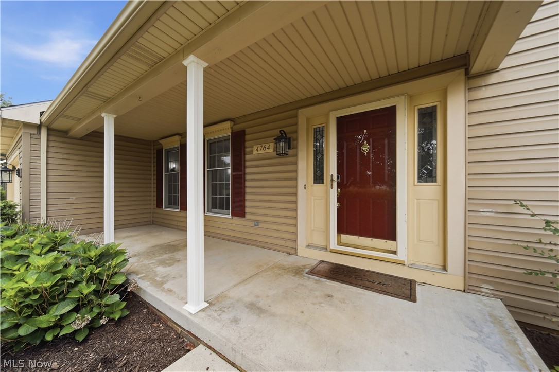 4764 Young Road Stow, OH 44224 - Photo 3 of 41 Covered front porch featuring a rich red entry door with sidelights