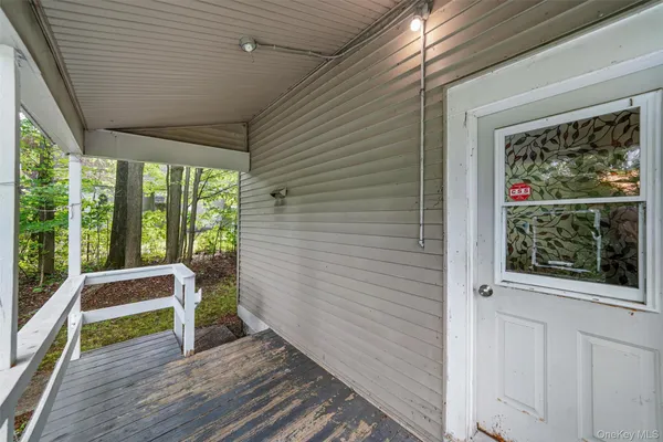 a view of front door and deck of the house