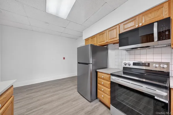a kitchen with wooden floor and steel stainless steel appliances