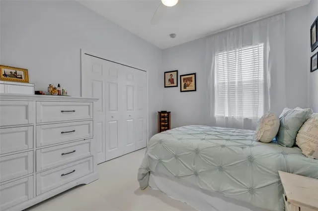 a view of patio with table and chairs under an umbrella with a small yard
