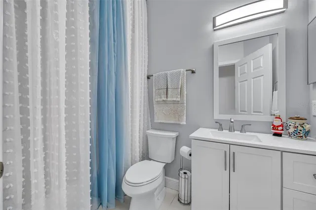 a view of a chair and table in backyard of the house