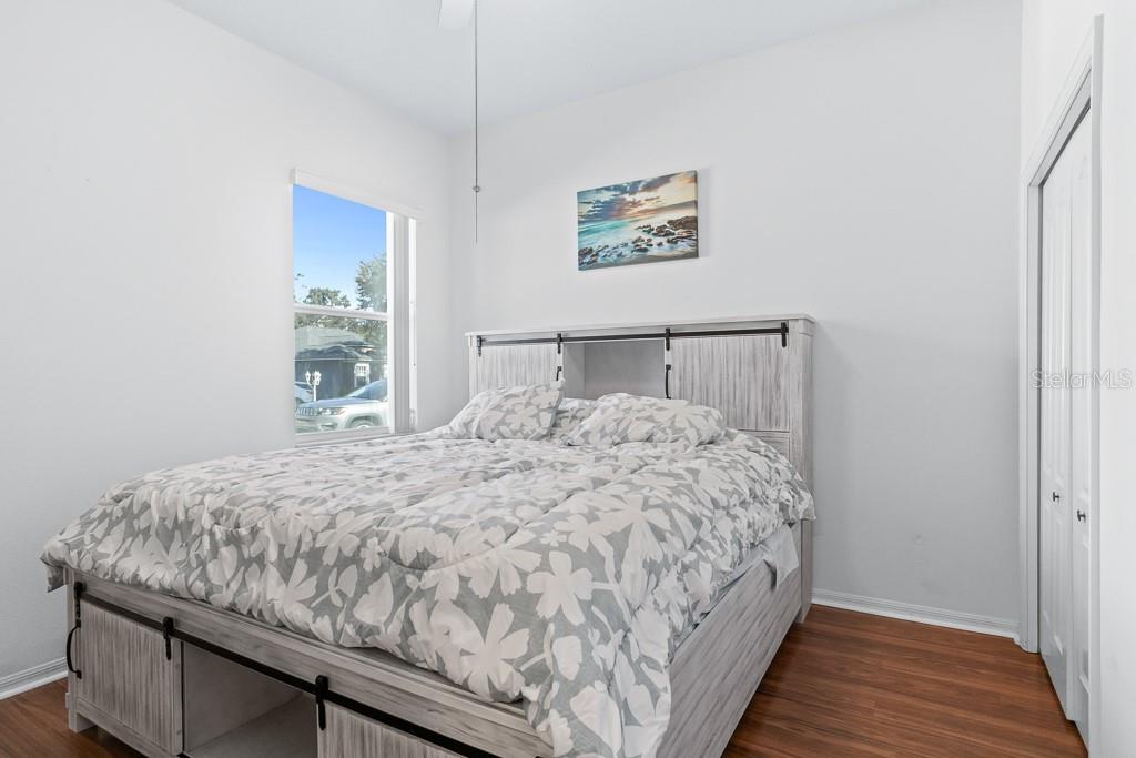 828 Innergary Place Valrico, FL 33594 - Photo 15 of 20 a bedroom with a bed and painting on the wall