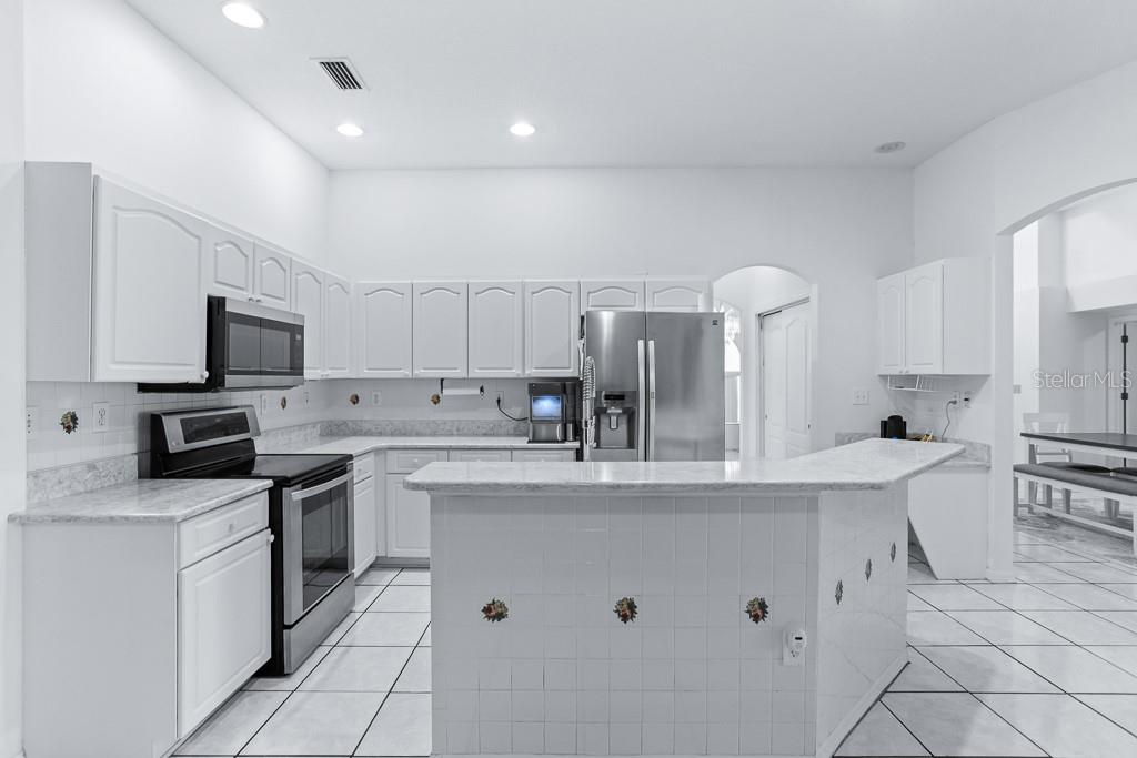 828 Innergary Place Valrico, FL 33594 - Photo 6 of 20 a kitchen with counter top space cabinets and appliances