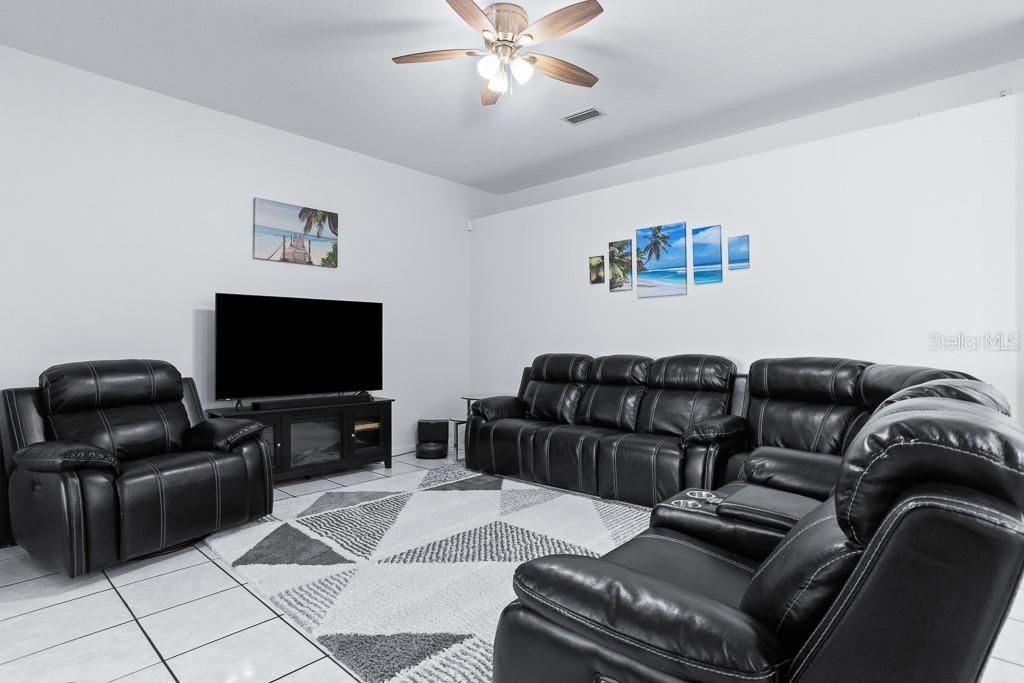828 Innergary Place Valrico, FL 33594 - Photo 9 of 20 a living room with furniture and a flat screen tv
