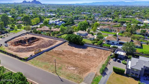 a view of a yard with wooden fence