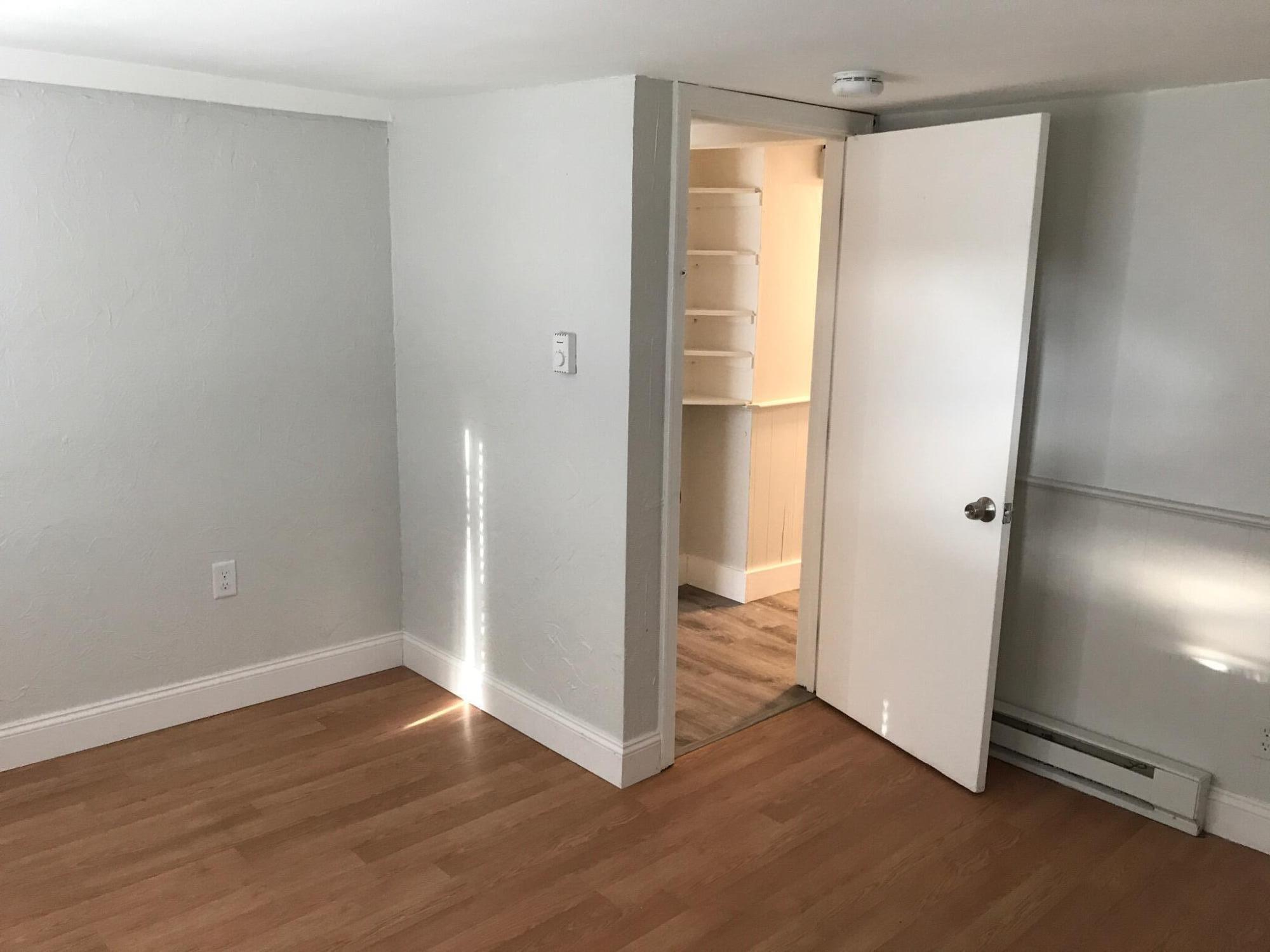 104 High School Road Hyannis, MA 02601 - Photo 6 of 14 a view of an empty room with wooden floor and a window
