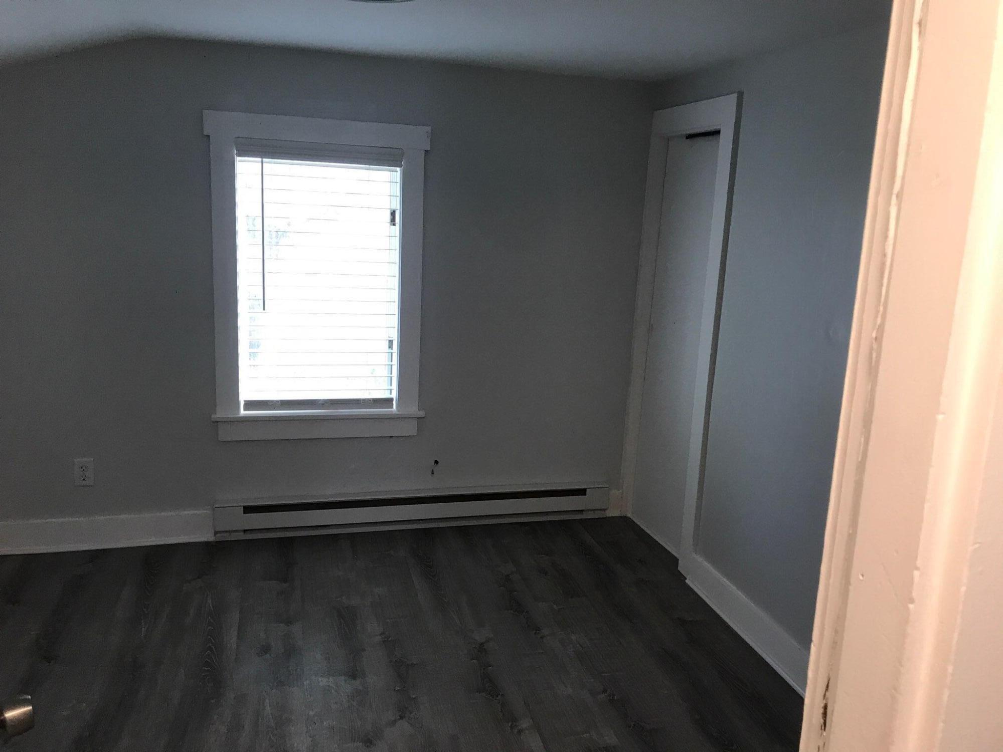 104 High School Road Hyannis, MA 02601 - Photo 7 of 14 an empty room with wooden floor and windows