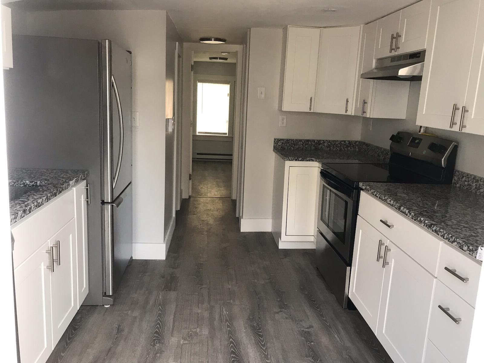 104 High School Road Hyannis, MA 02601 - Photo 9 of 14 a kitchen with granite countertop a refrigerator and a stove top oven