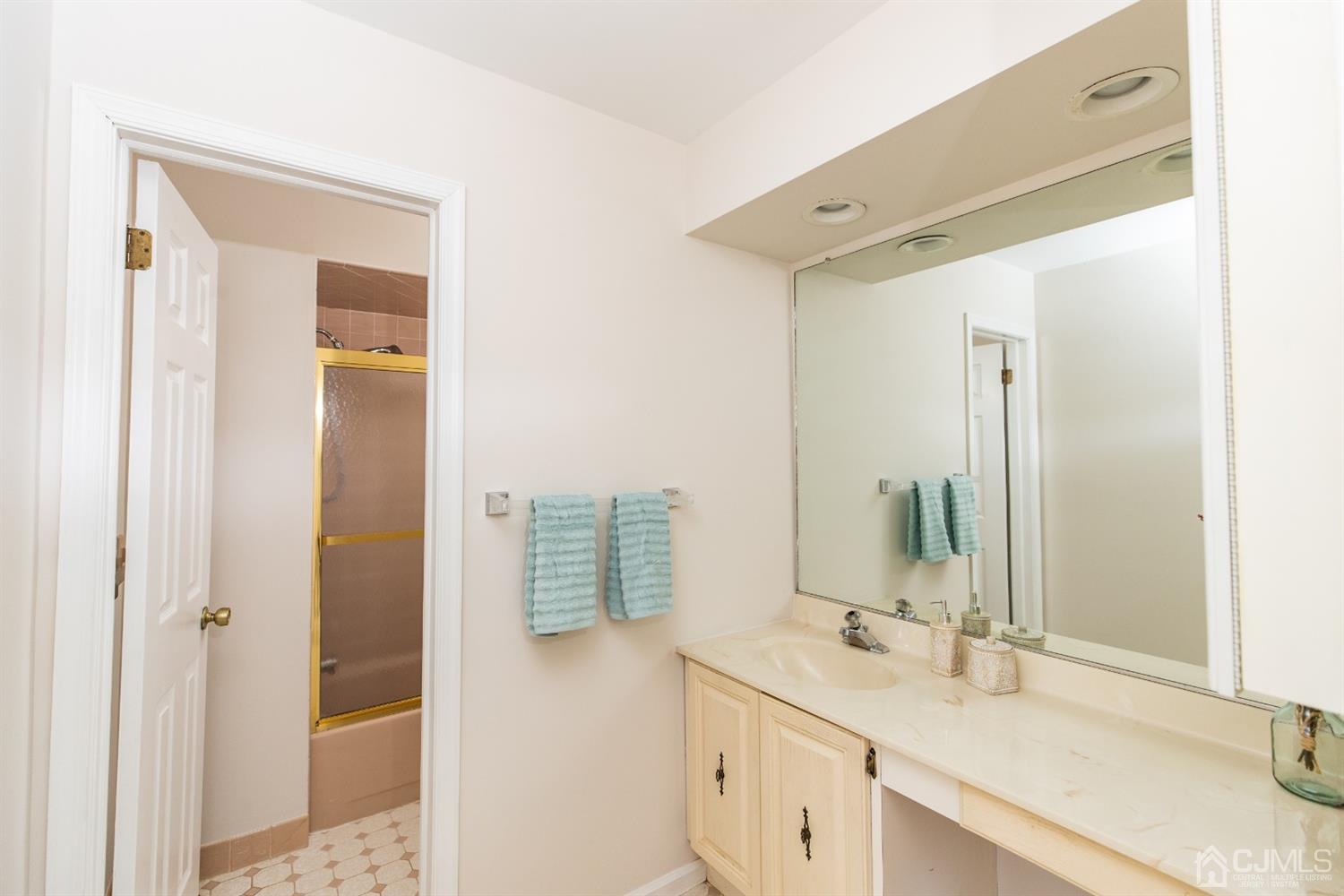 1601 Timber Oaks Road Edison, NJ 08820 - Photo 19 of 29 a bathroom with a double vanity sink and mirror