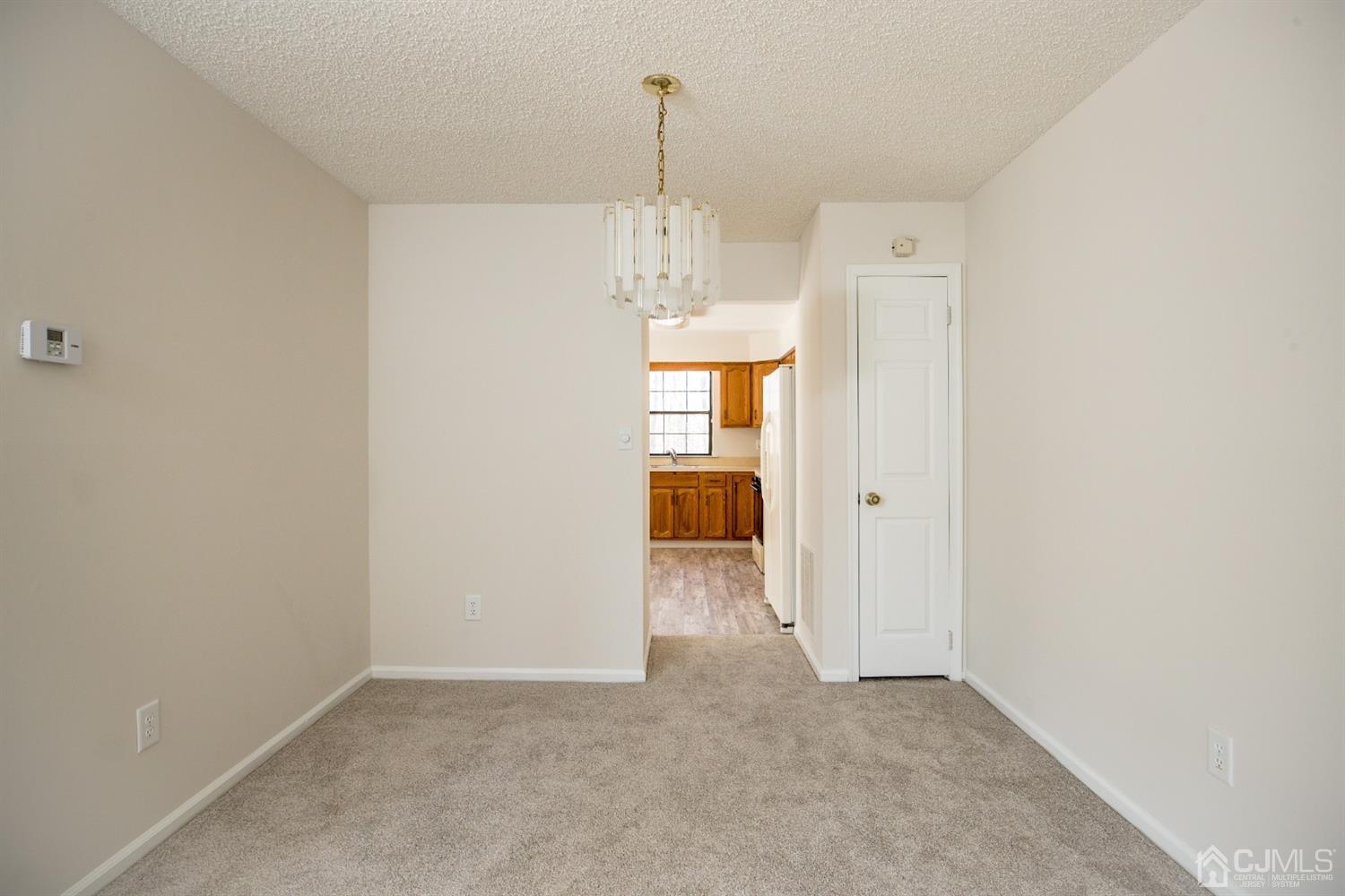 1601 Timber Oaks Road Edison, NJ 08820 - Photo 5 of 29 a view of a hallway with wooden floor and a window
