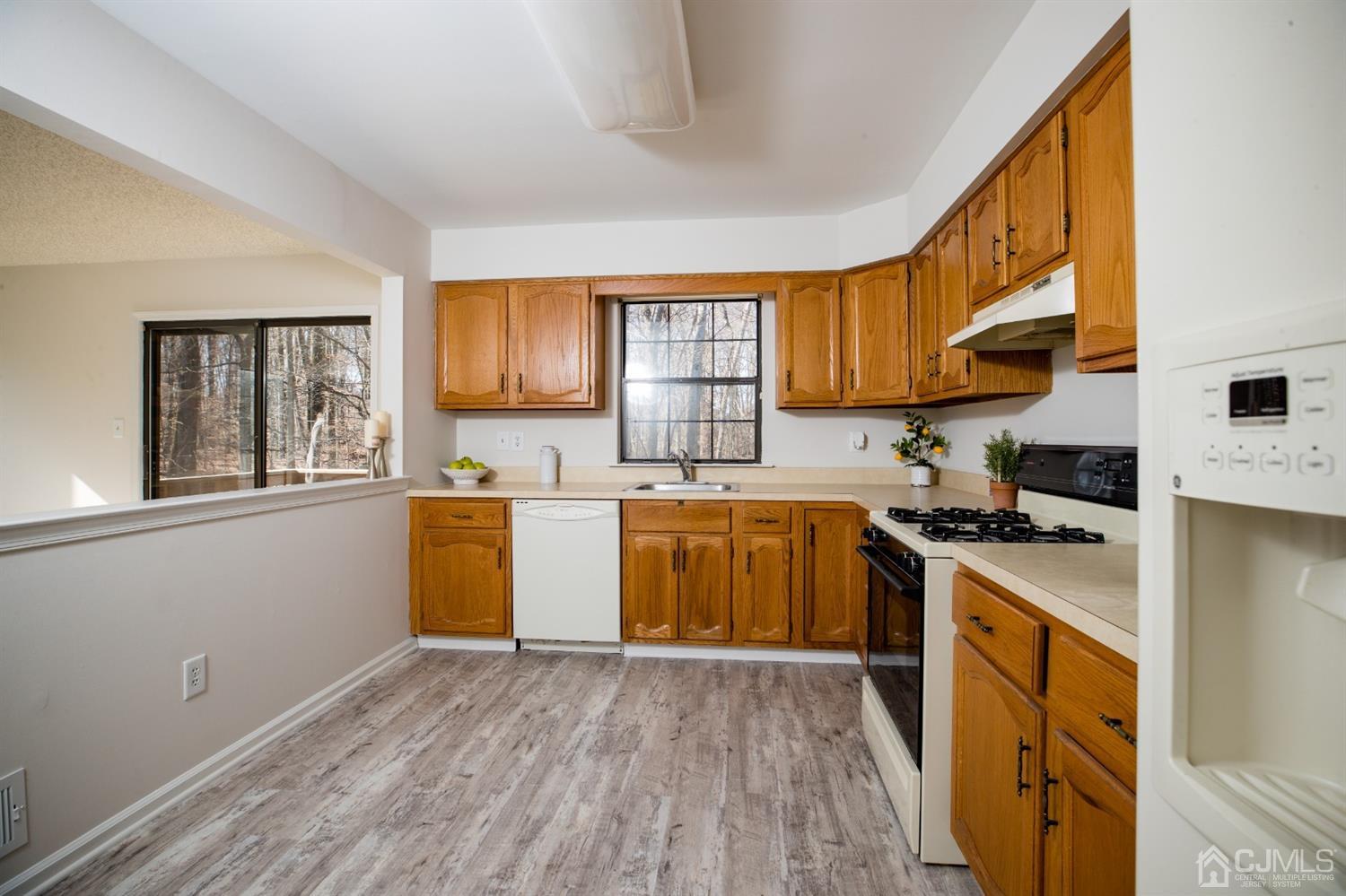 1601 Timber Oaks Road Edison, NJ 08820 - Photo 8 of 29 a kitchen with a sink wooden floor and stainless steel appliances