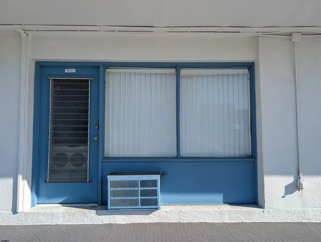 a view of room with a flat screen tv and a refrigerator