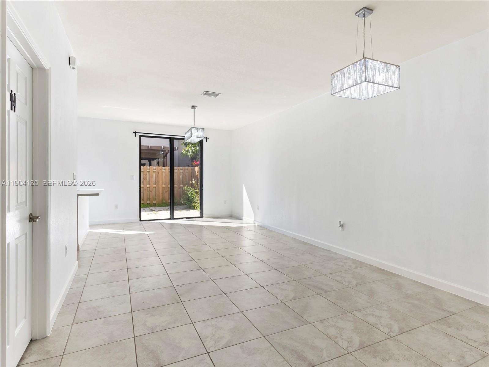 11410 Southwest 252nd Terrace Homestead, FL 33032 - Photo 11 of 38 a view of an empty room with chandelier and window