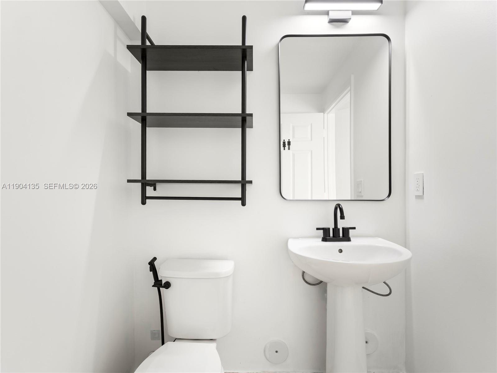 11410 Southwest 252nd Terrace Homestead, FL 33032 - Photo 12 of 38 a bathroom with a sink and mirror