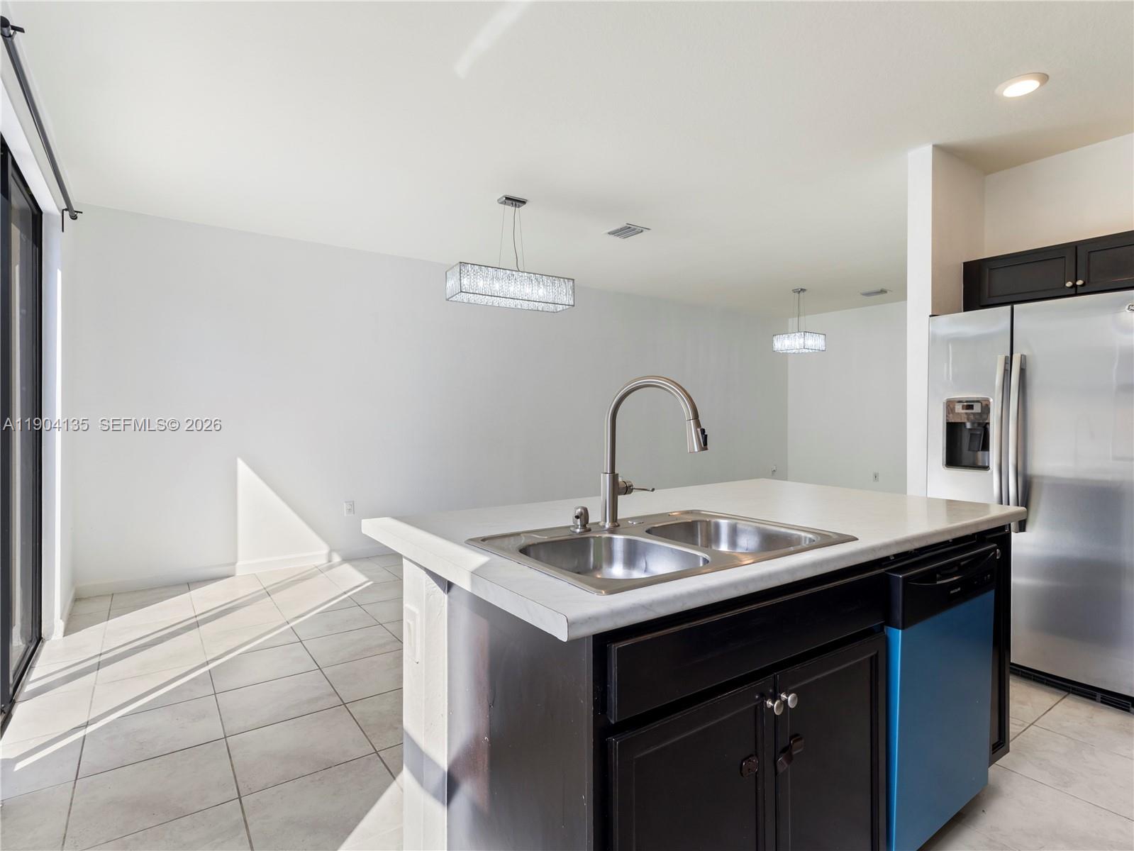 11410 Southwest 252nd Terrace Homestead, FL 33032 - Photo 18 of 38 a sink with a faucet and white cabinets