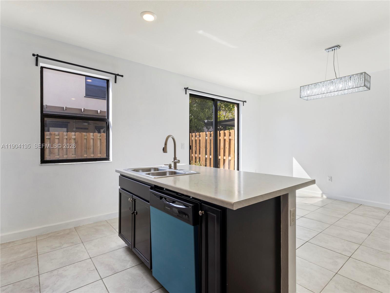 11410 Southwest 252nd Terrace Homestead, FL 33032 - Photo 19 of 38 a kitchen with a sink and a stove