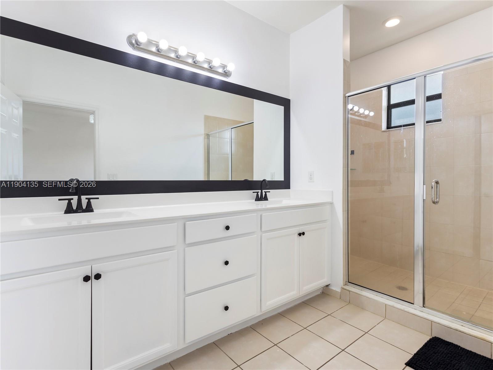 11410 Southwest 252nd Terrace Homestead, FL 33032 - Photo 24 of 38 a bathroom with a double vanity sink and mirror