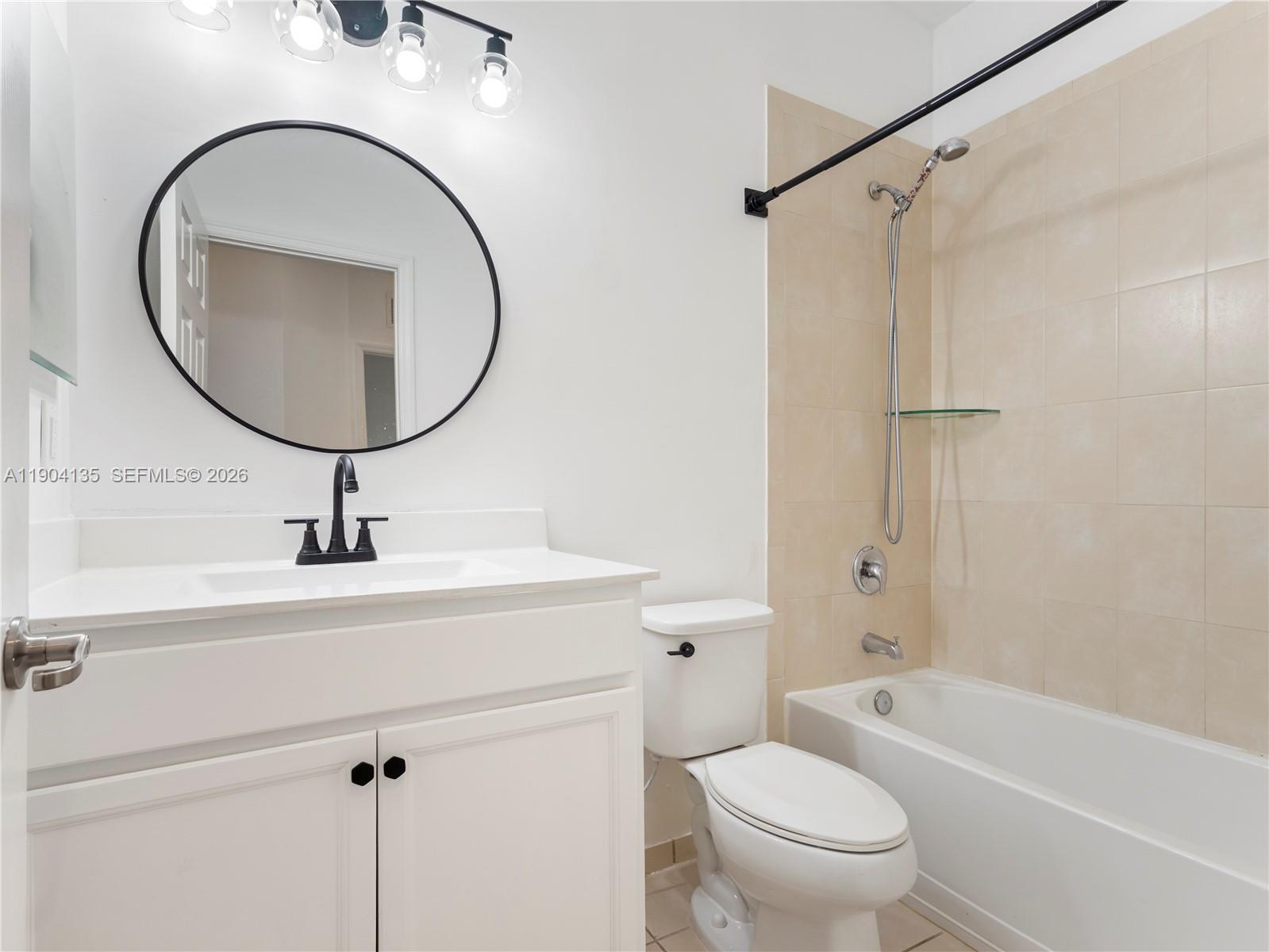 11410 Southwest 252nd Terrace Homestead, FL 33032 - Photo 34 of 38 a bathroom with a sink a mirror a toilet and a shower