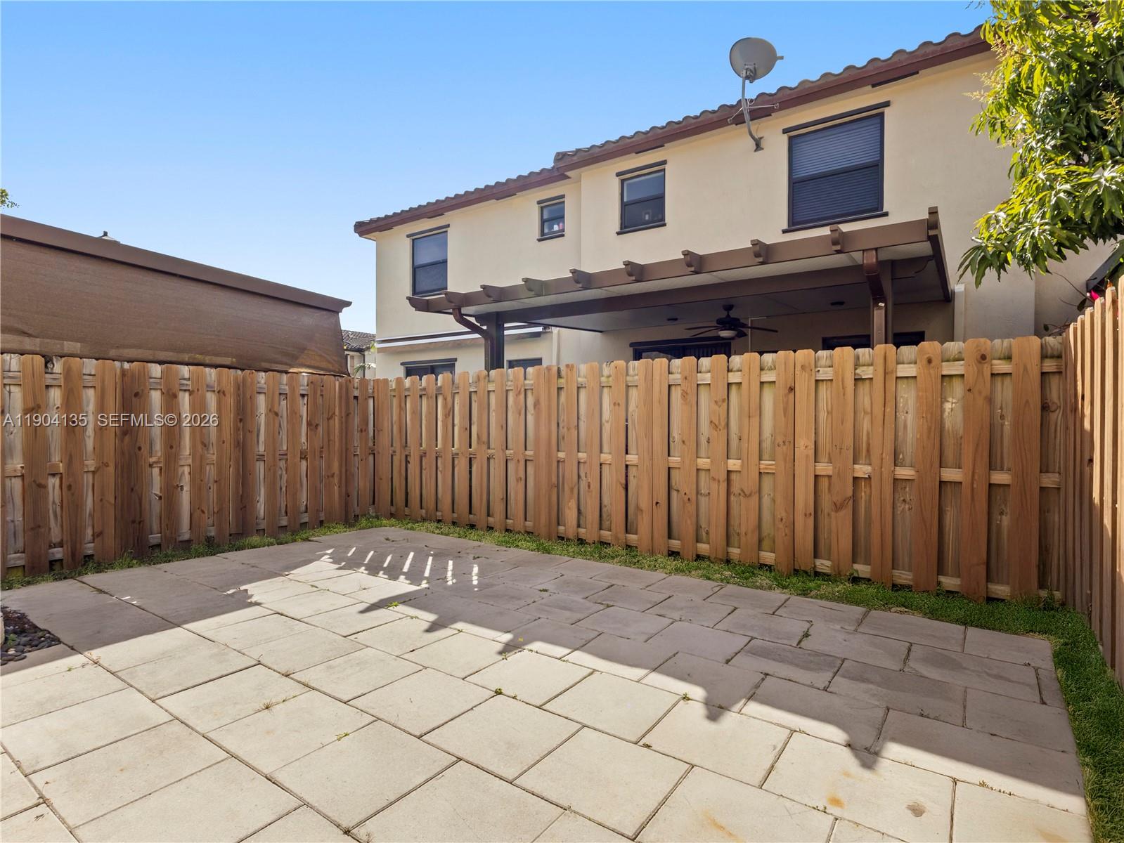 11410 Southwest 252nd Terrace Homestead, FL 33032 - Photo 37 of 38 a view of a white house with a large window and wooden fence