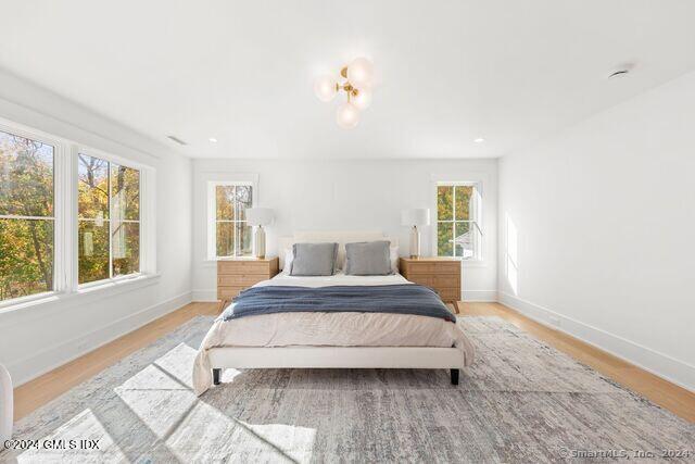 77 Stanton Road Darien, CT 06820 - Photo 25 of 39 a spacious bedroom with a large bed and a window