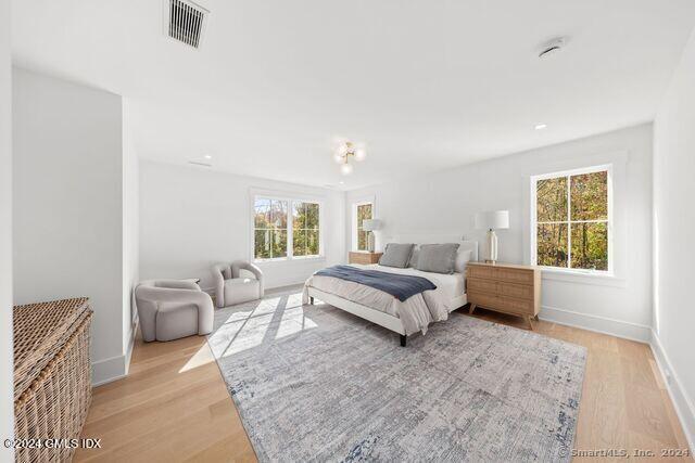 77 Stanton Road Darien, CT 06820 - Photo 26 of 39 a spacious bedroom with a bed and a couch