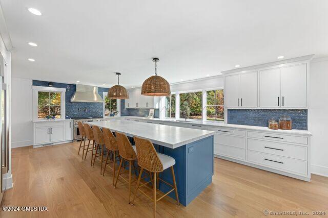 77 Stanton Road Darien, CT 06820 - Photo 9 of 39 a kitchen with stainless steel appliances granite countertop a stove a sink dishwasher and a dining table with wooden floor