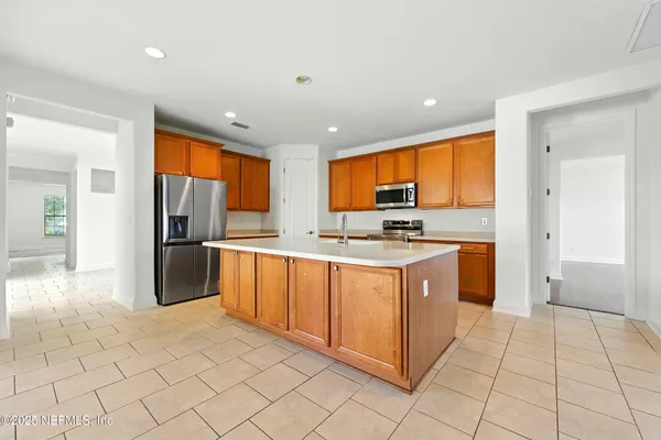 a kitchen with stainless steel appliances granite countertop a sink a stove and a refrigerator