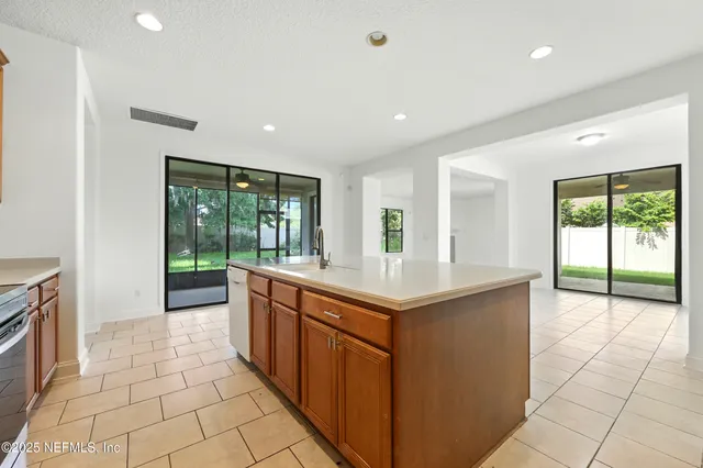 a kitchen with granite countertop a sink and cabinets