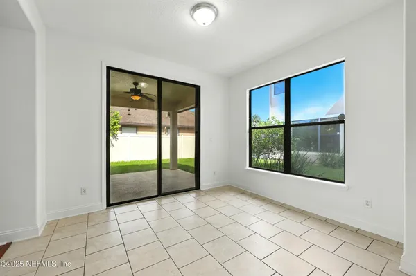 a view of a big room with wooden floor and mirror