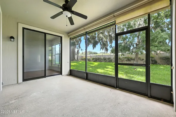 an aerial view of residential houses with outdoor space and trees all around